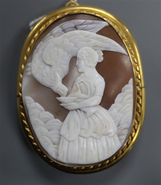 A gilt metal mounted oval cameo pendant brooch, carved with Diana & the Eagle, 65mm.